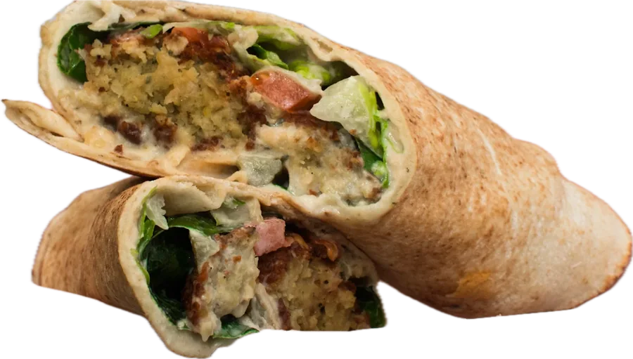 Falafel wrap cut in half, showing falafel, hummus, lettuce and tomato