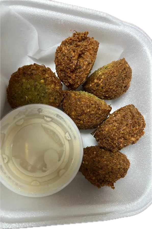 Crispy falafel with a cup of tahini sauce