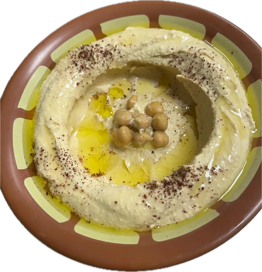 Hummus topped with olive oil, sumac and chickpeas